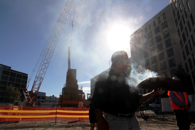 Aboriginal elder Uncle Bill Smith conducts a smoking ceremony on the site of Newcastle's new court complex.