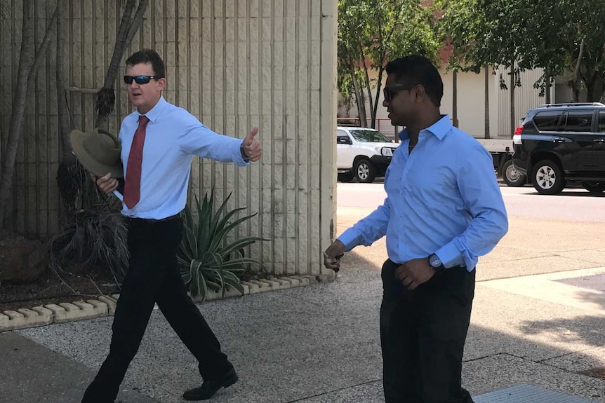 Keerthi Eswaran and his lawyer Peter Maley walk away from court in Darwin.