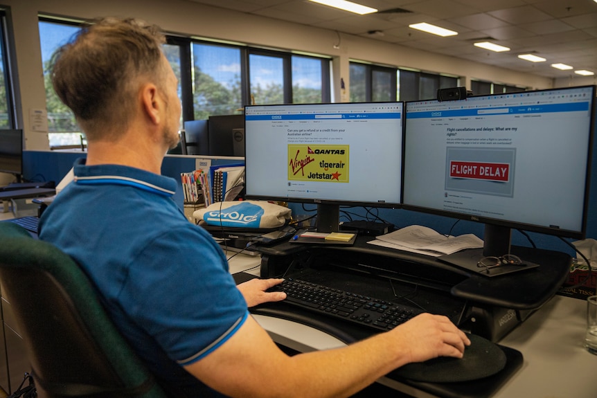 A man sits in front of a computer.