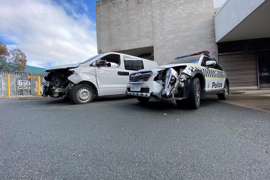 A van and a police car have serious damage to their front bumpers.