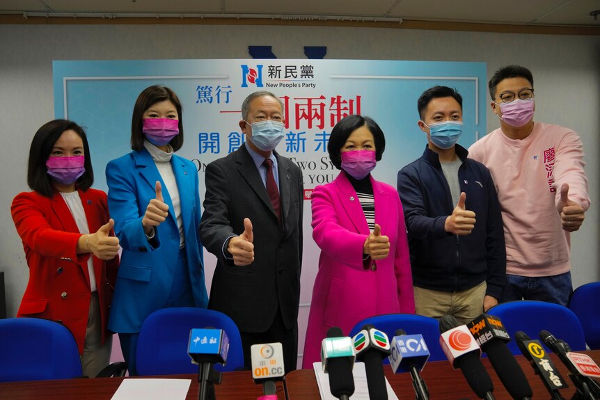 Grupa kandydatów w wyborach podnosi kciuki, żeby zrobić zdjęcie