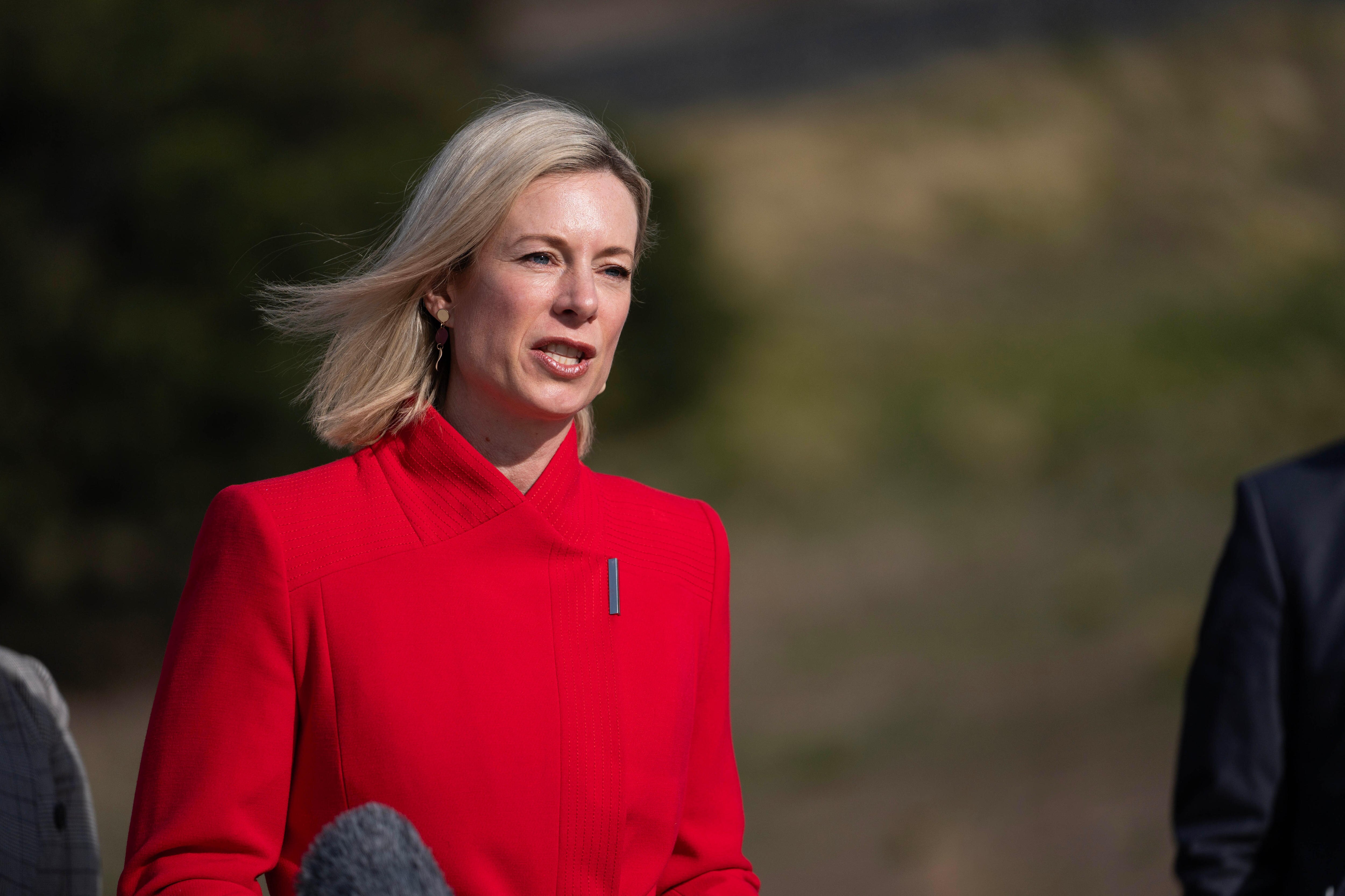 Blonde woman wearing a bright red coat 