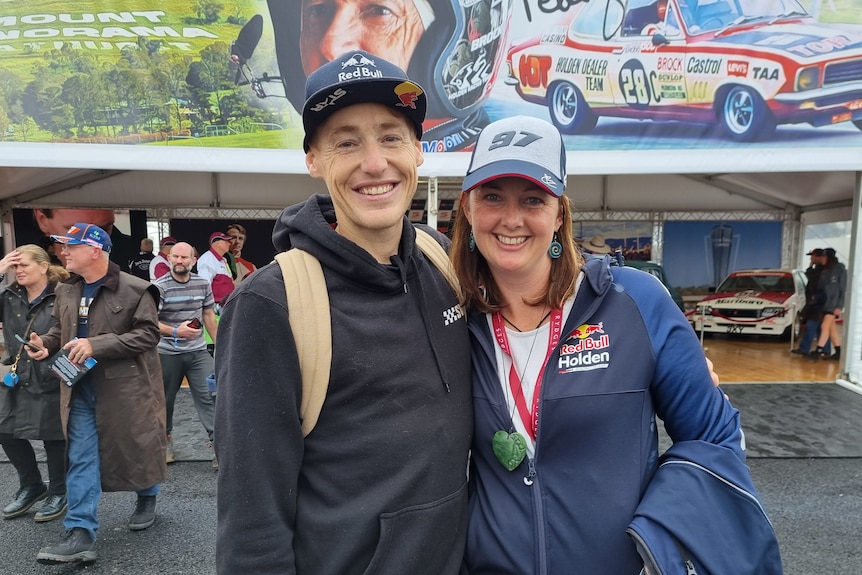 A young male and female wearing Red Bull racing gear 