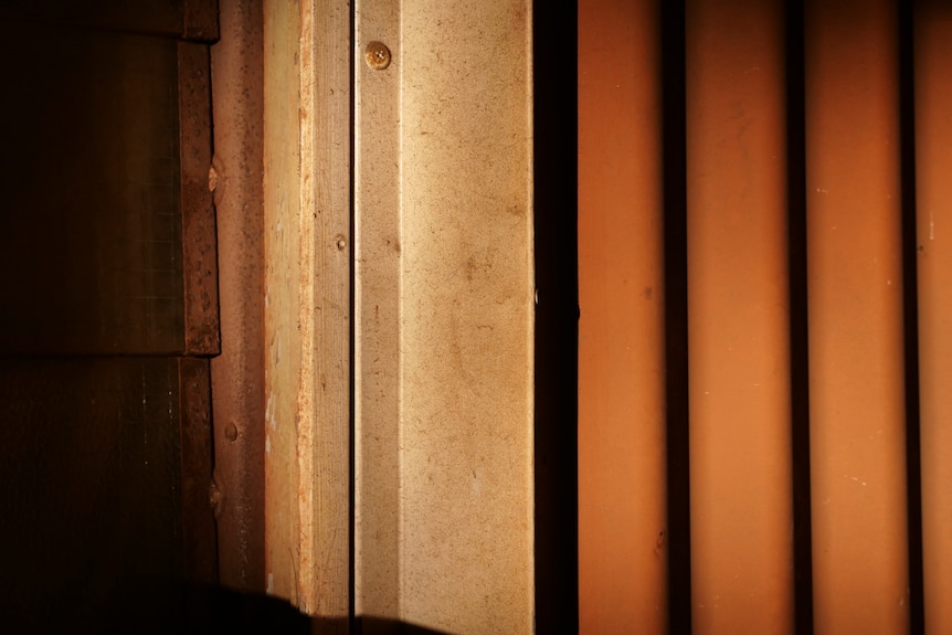 A close up of a wall covered in red dust.