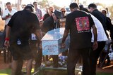 Cleveland Dodd's casket being carried to his grave.