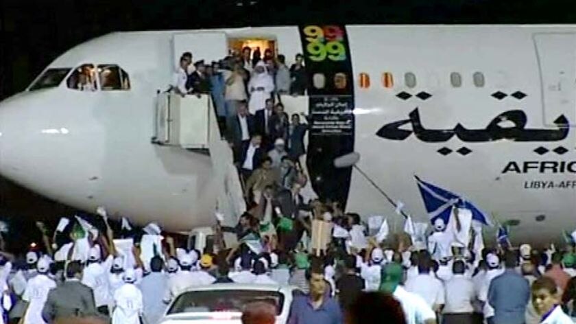 Welcomed back: Megrahi is greeted as he arrives in Libya
