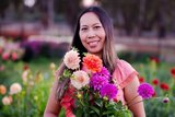 Woman hold flowers smiling