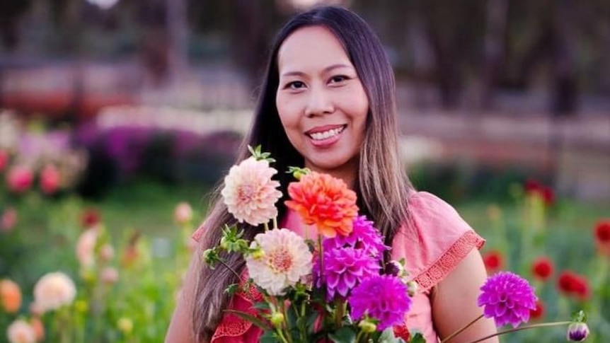 Woman hold flowers smiling