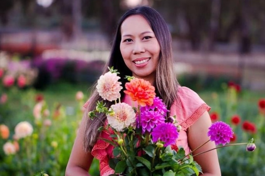 Woman hold flowers smiling