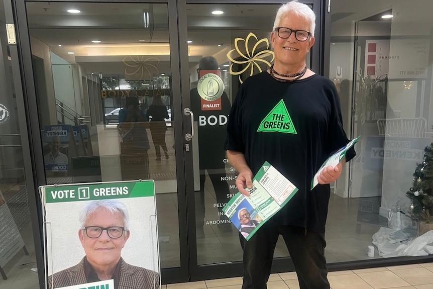the candidate for the greens party wearing glasses standing outside a pre poll booth ahead of cook byelection