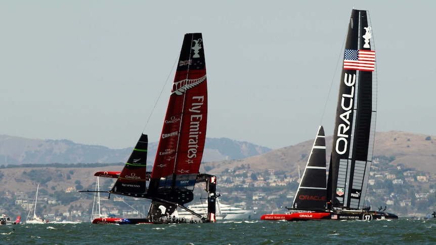 Team New Zealand (L) sailing on one hull against Oracle Team USA in race eight of the America's Cup.
