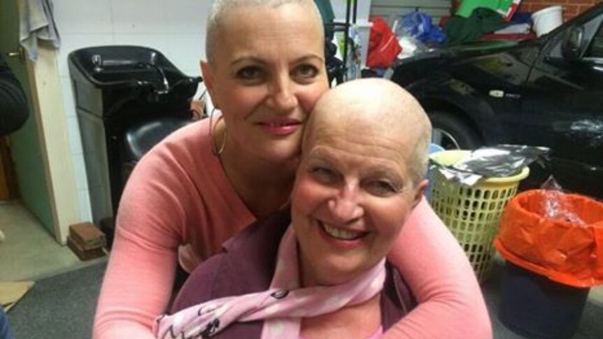 Pamella and her daughter with their shaved heads.