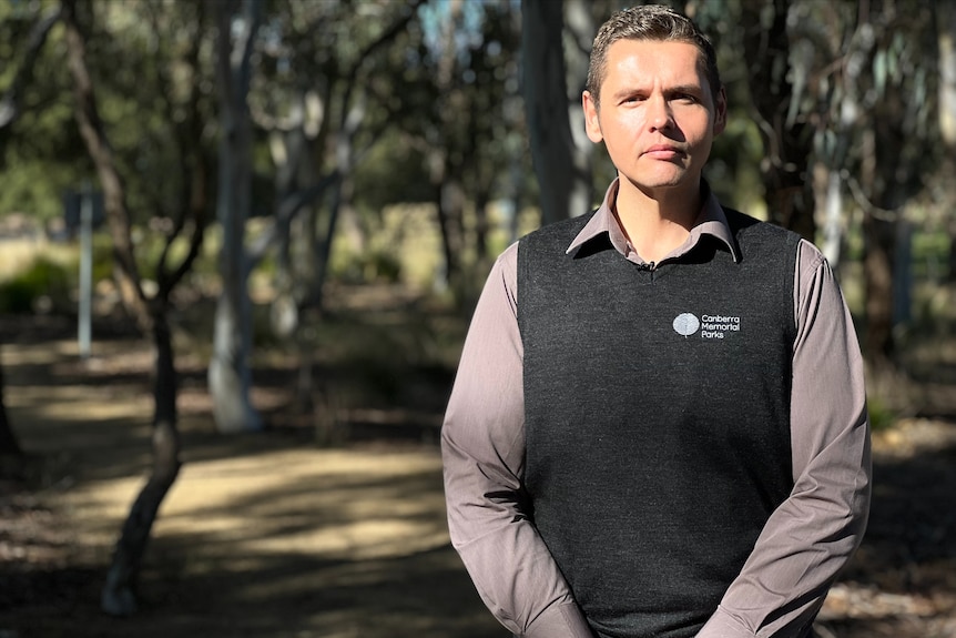 a man standing in front of a large park