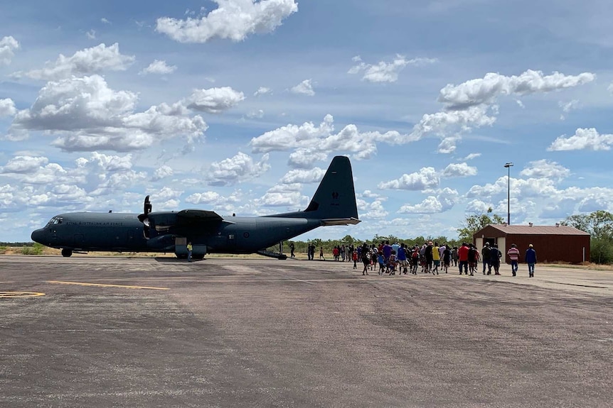 Evacuees from Cyclone Trevor ready to board the Hercules in Borroloola.