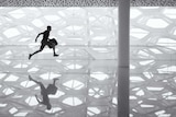 Man running, holding bag, geometrical, hexagonal background