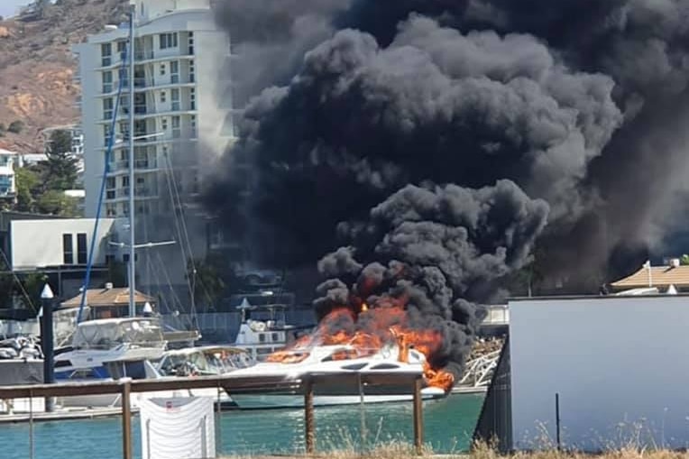 boat on fire at townsville marina black smoke billowing