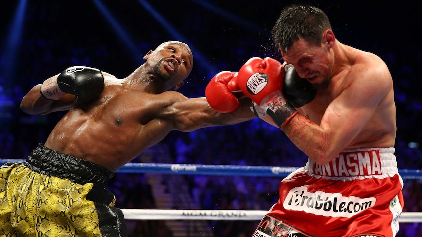 Floyd Mayweather throws a left to the face of Robert Guerrero in their WBC title fight.