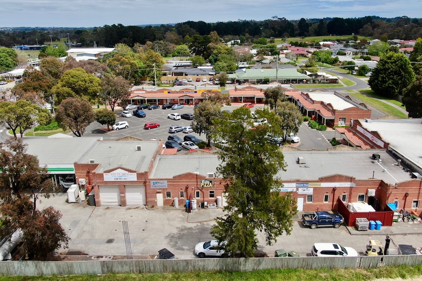 A drone shot of a shopping strip in a semi-rural setting