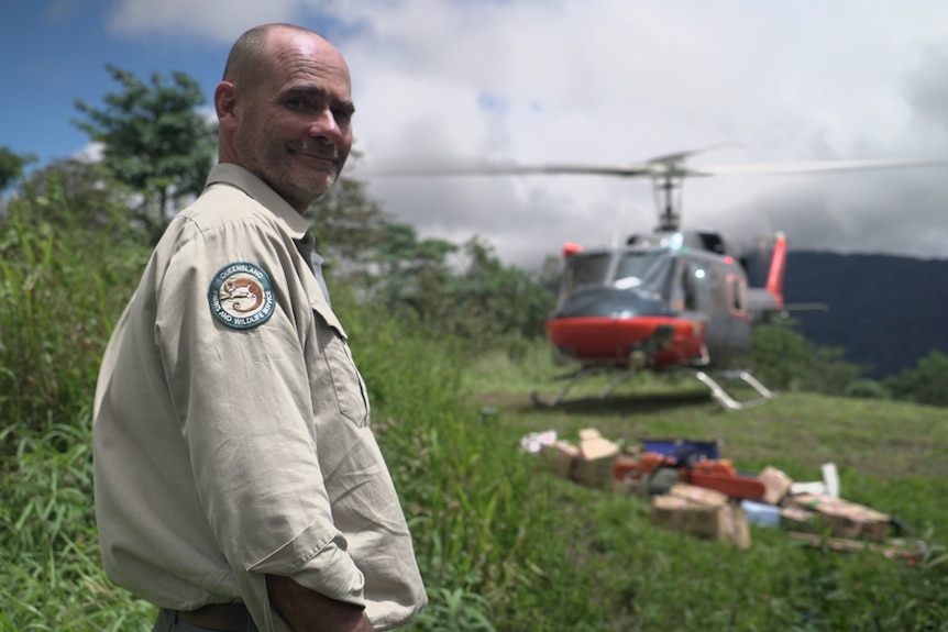Ranger Stuart Johnson waits to unload tools and supplies from a PNGDF helicopter at Launumu village on the Kokoda Track.