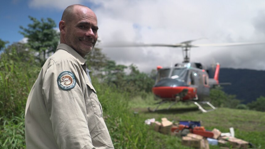 Ranger Stuart Johnson waits to unload tools and supplies from a PNGDF helicopter at Launumu village on the Kokoda Track.