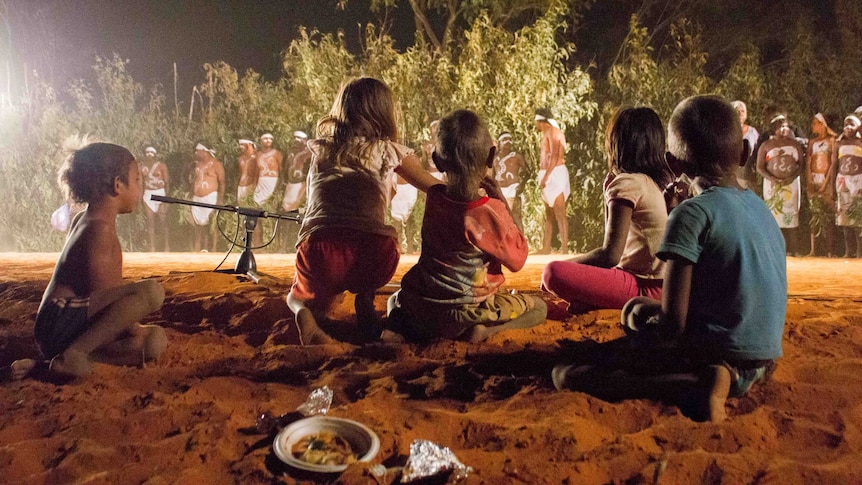 Indigenous children watch traditional dancing at a Kimberley cultural festival.