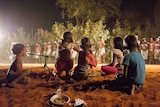 Indigenous children watch traditional dancing at a Kimberley cultural festival.