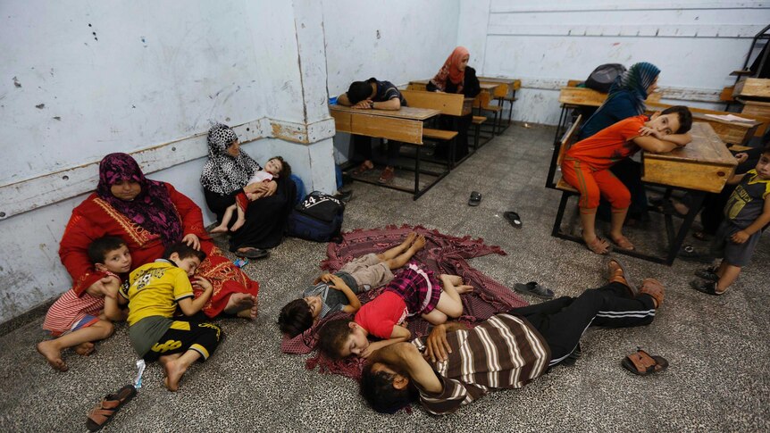 Palestinians take shelter at a UN school after evacuating their homes near the border in Gaza City.