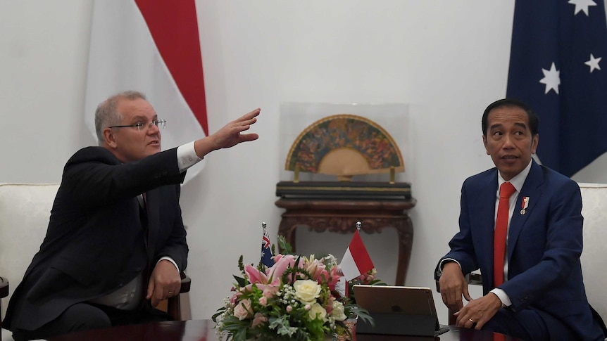 Australian Prime Minister Scott Morrison gestures as he talks with Indonesian President Joko Widodo.