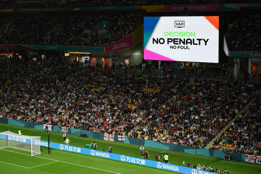 A big screen shows VAR's decision to overturn an England penalty during a Women's World Cup game ag