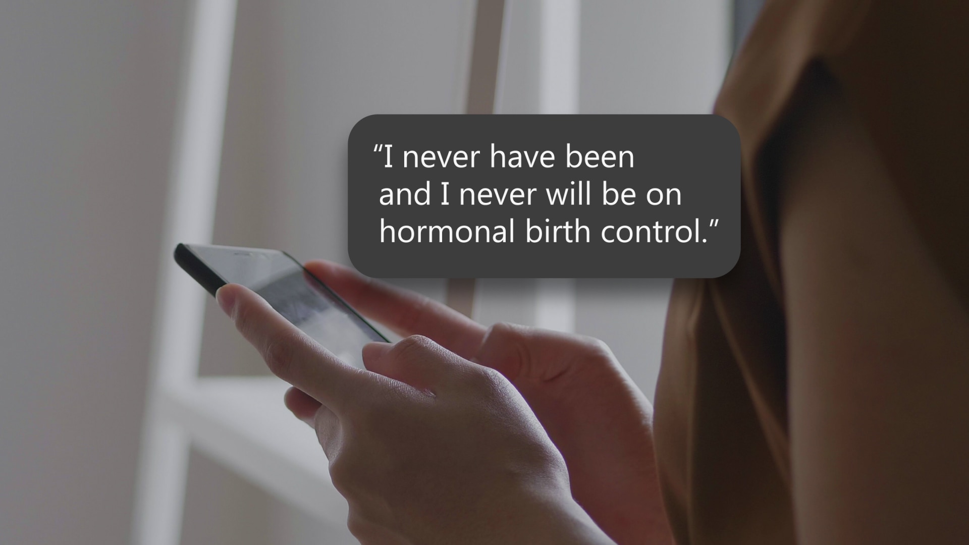 woman holds a phone.