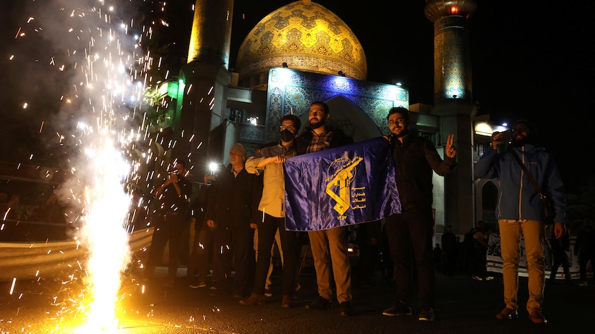 Iranians celebrate on a street, after the IRGC attack on Israel.