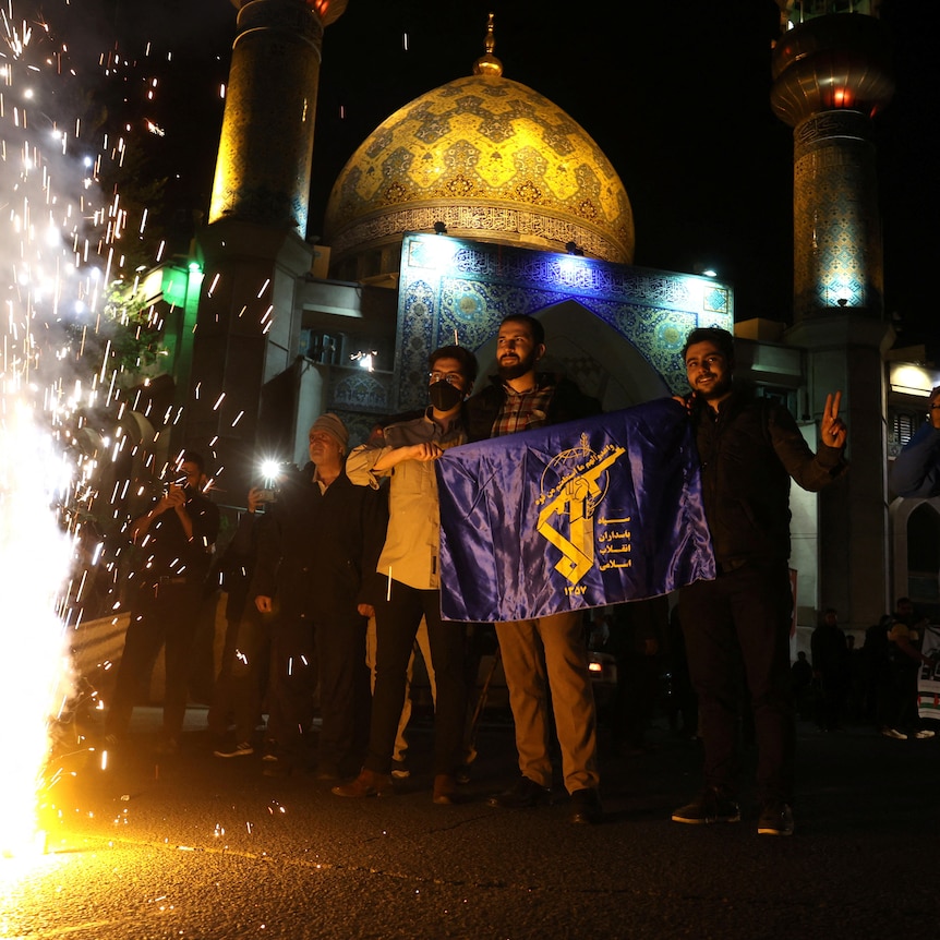 Iranians celebrate on a street, after the IRGC attack on Israel.