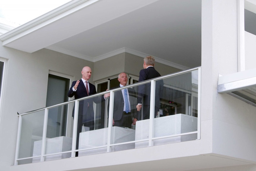 Sean L'Strange, with Paul Miles and the Premier Colin Barnett standing on an apartment balcony.