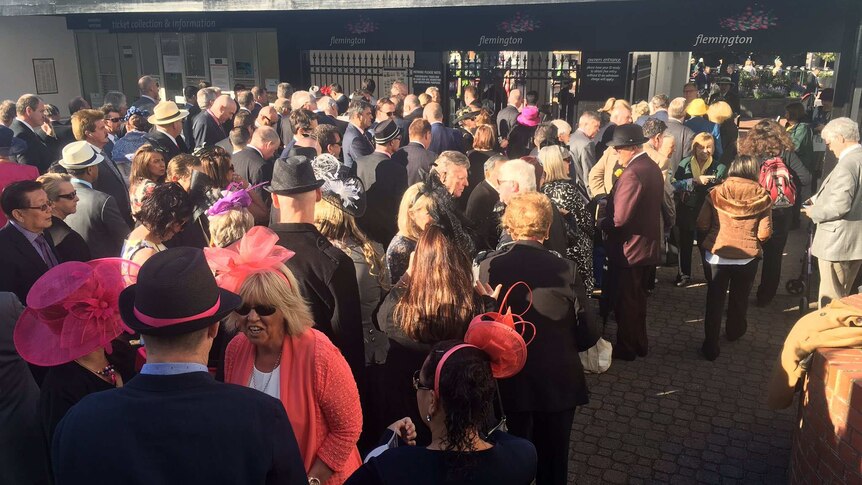 Punters line up outside Flemington on Melbourne Cup day