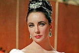 Elizabeth Taylor wearing emerald and diamond brooch