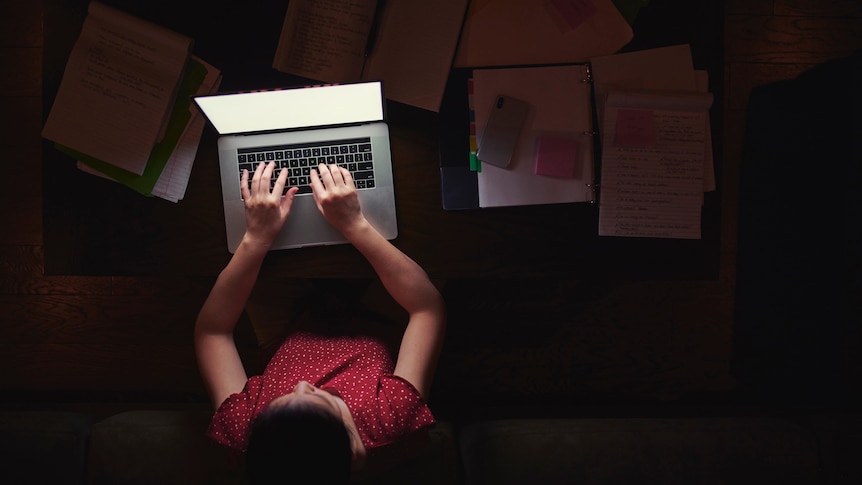 Woman working from home late at night - stock photo