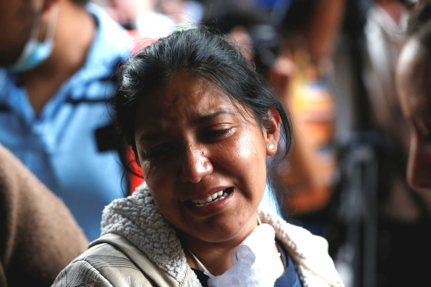 A relative cries as Maria Ortiz's body is recovered.