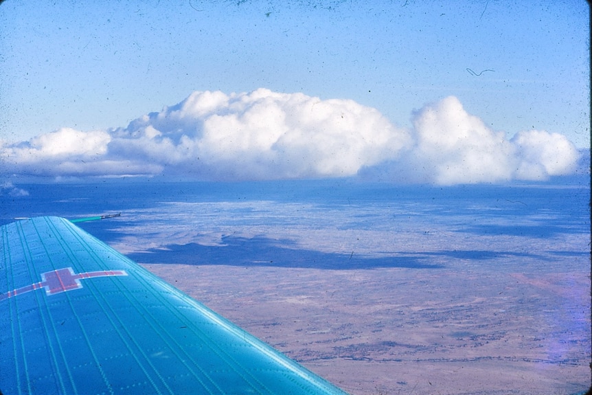 An old RFDS plane flies over Far West NSW.