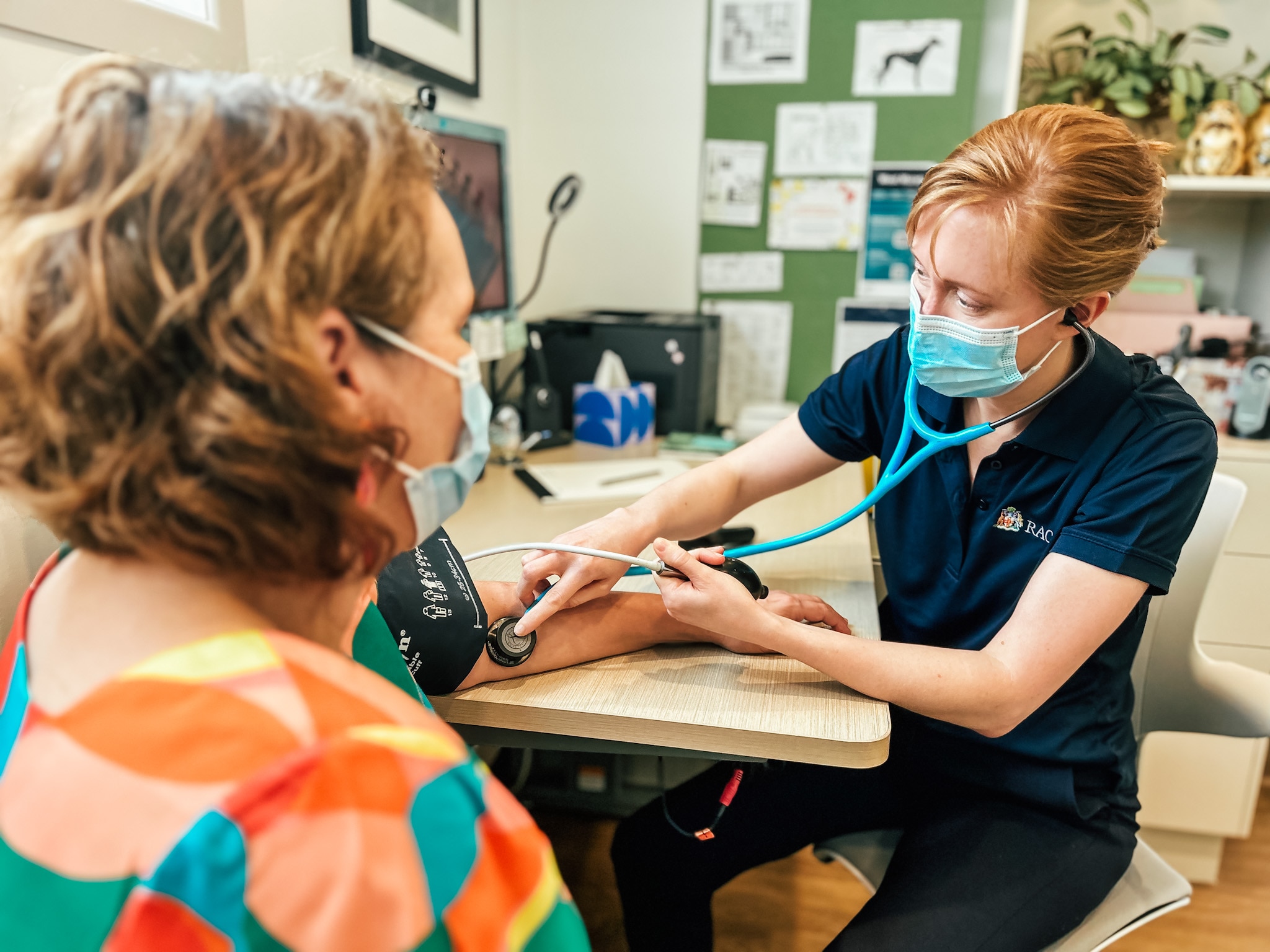 a doctor checks a patient's blood pressure