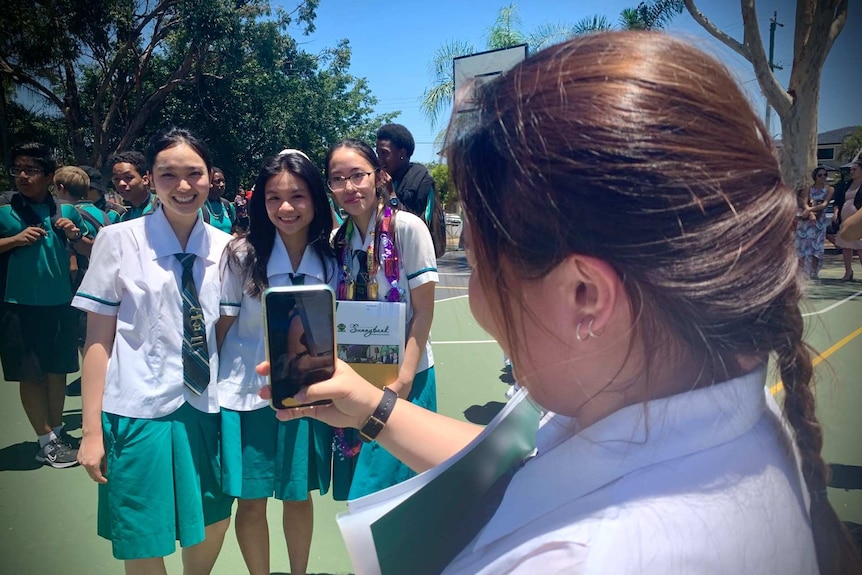 Monica Vu gets her photo taken at graduation at Sunnybank State High School