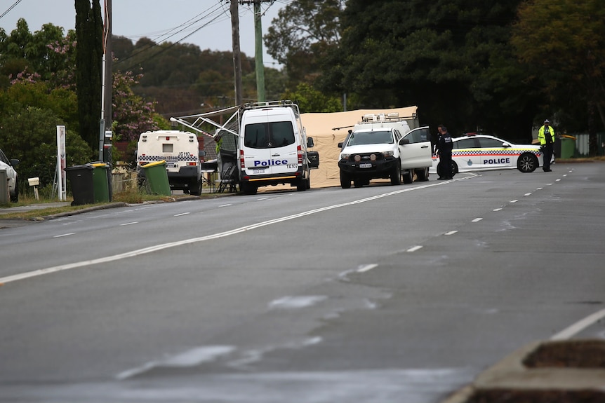Police vehicles parked outside a property on a street in Gosnells.
