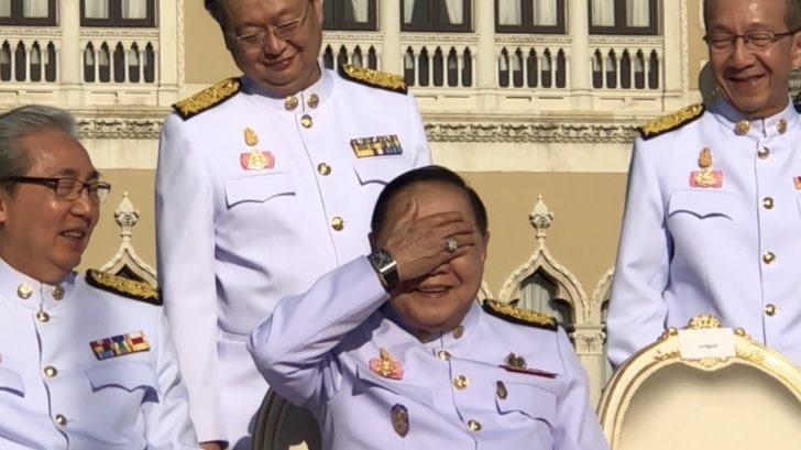 Deputy Prime Minister Prawit Wongsuwan shields his eyes from the sun, revealing the $100,000 watch that started the scandal. 