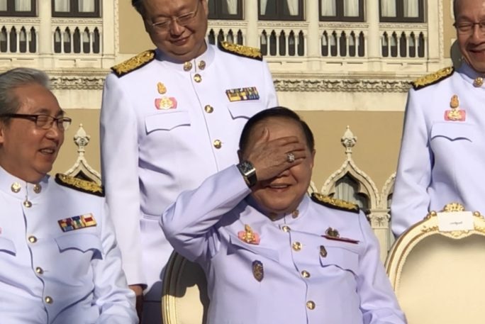 Deputy Prime Minister Prawit Wongsuwan shields his eyes from the sun, revealing the $100,000 watch that started the scandal. 