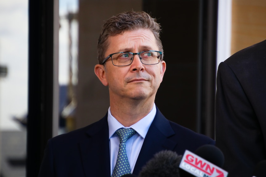 A mid-shot of WA Liberal MP Tjorn Sibma glancing upwards.