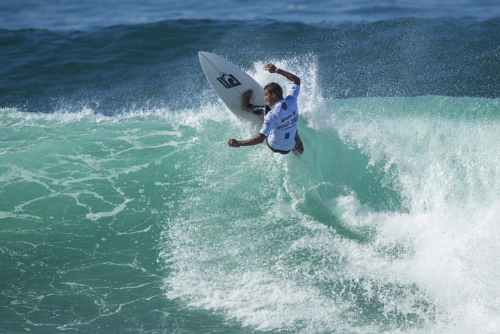 A surfer turns at the top of a pretty sizable wave.