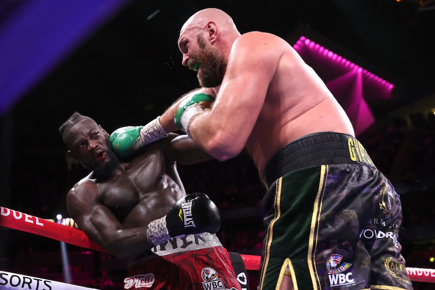 Tyson Fury punches Deontay Wilder
