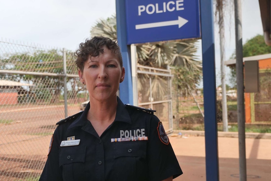 A photo of police officer Tanya Woodcock standing outside of a station in Wadeye.