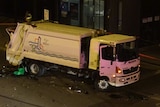 The garbage truck was damaged in the crash on Roe Street.