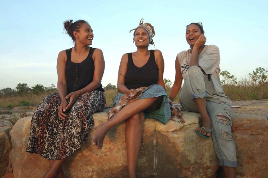 Alice Eather with her sisters Noni and Grace on a rock