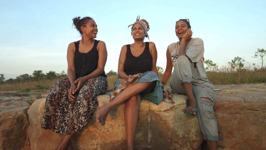 Alice Eather with her sisters Noni and Grace on a rock